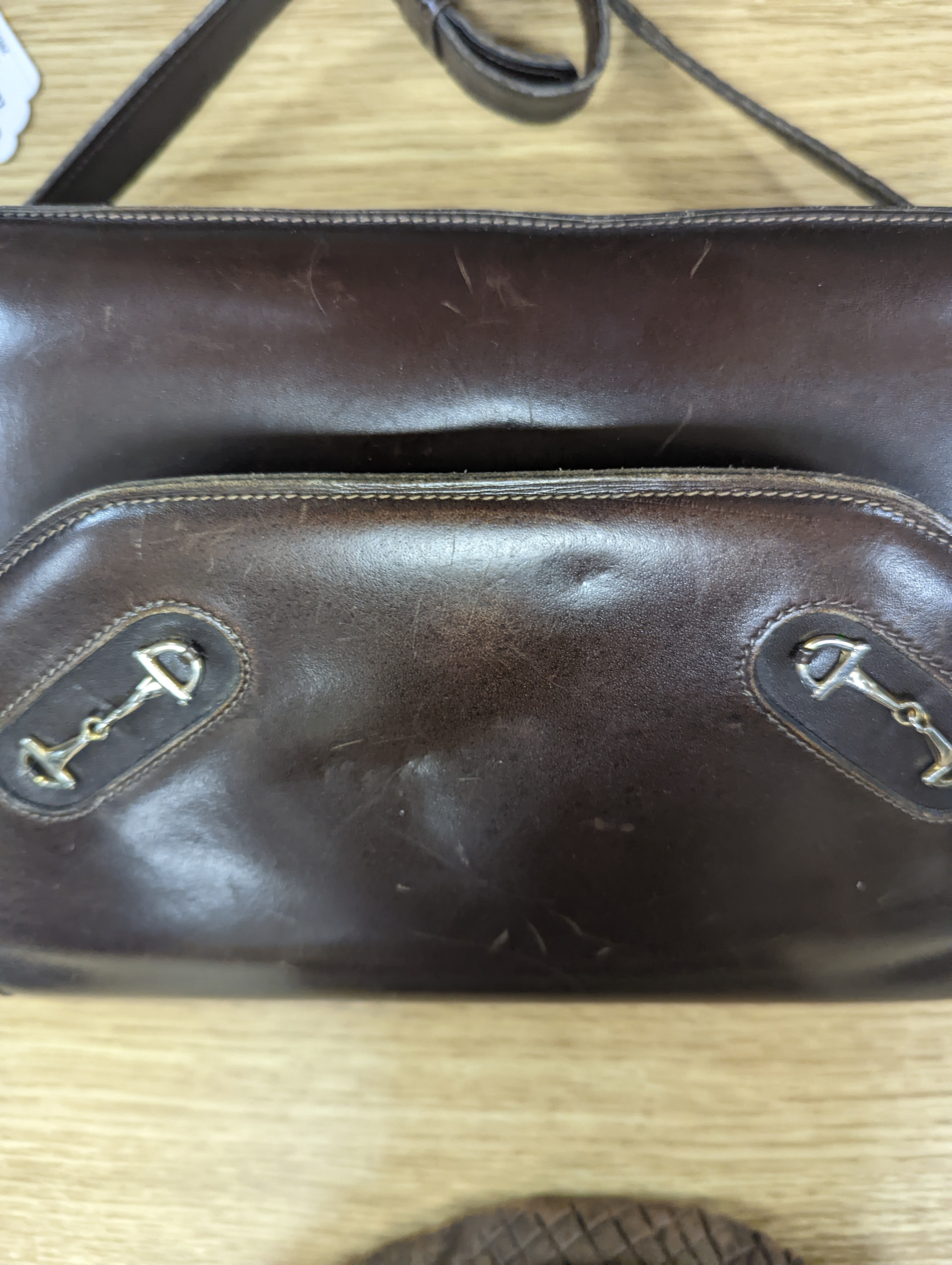 A vintage brown leather handbag stamped 